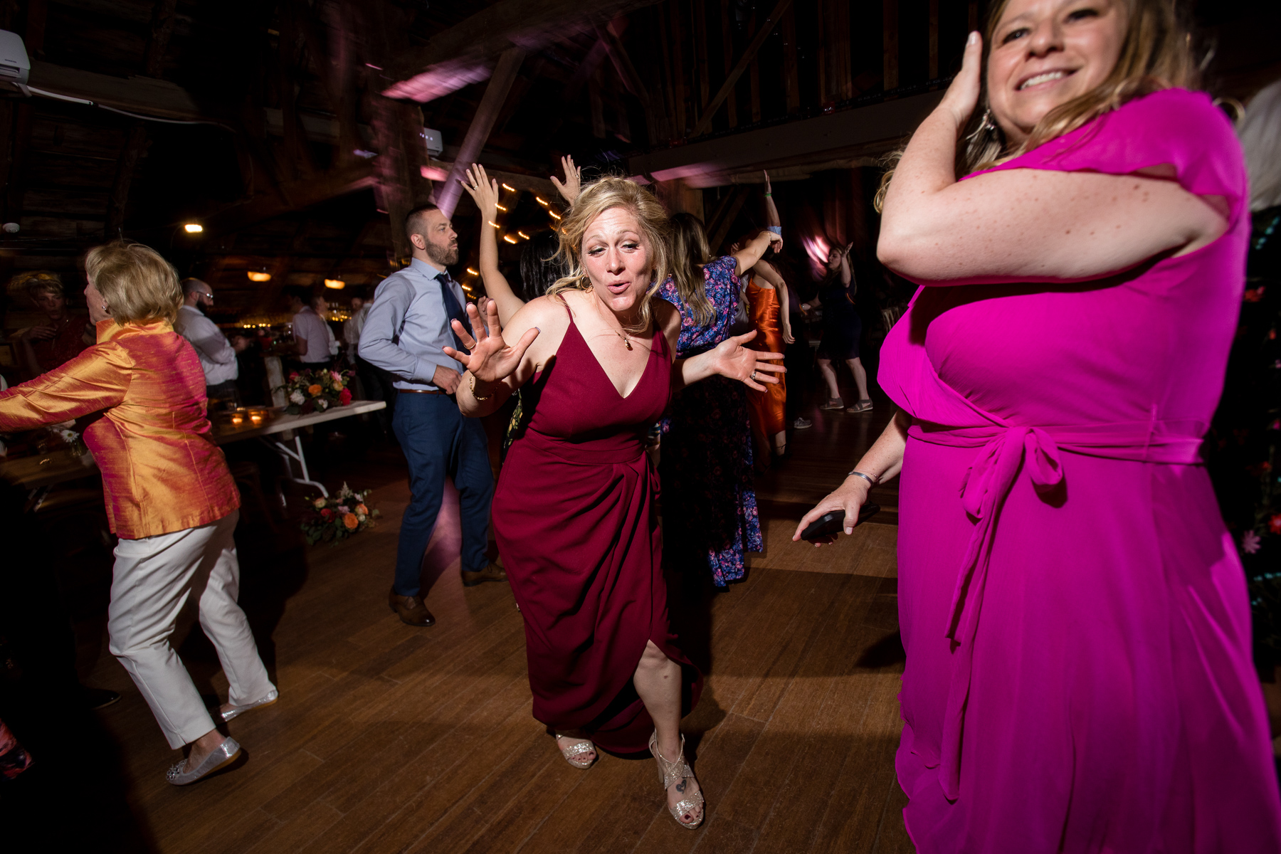 Guests dancing and enjoying themselves at a wedding reception in the renovated barn at Blenheim Hill Farm