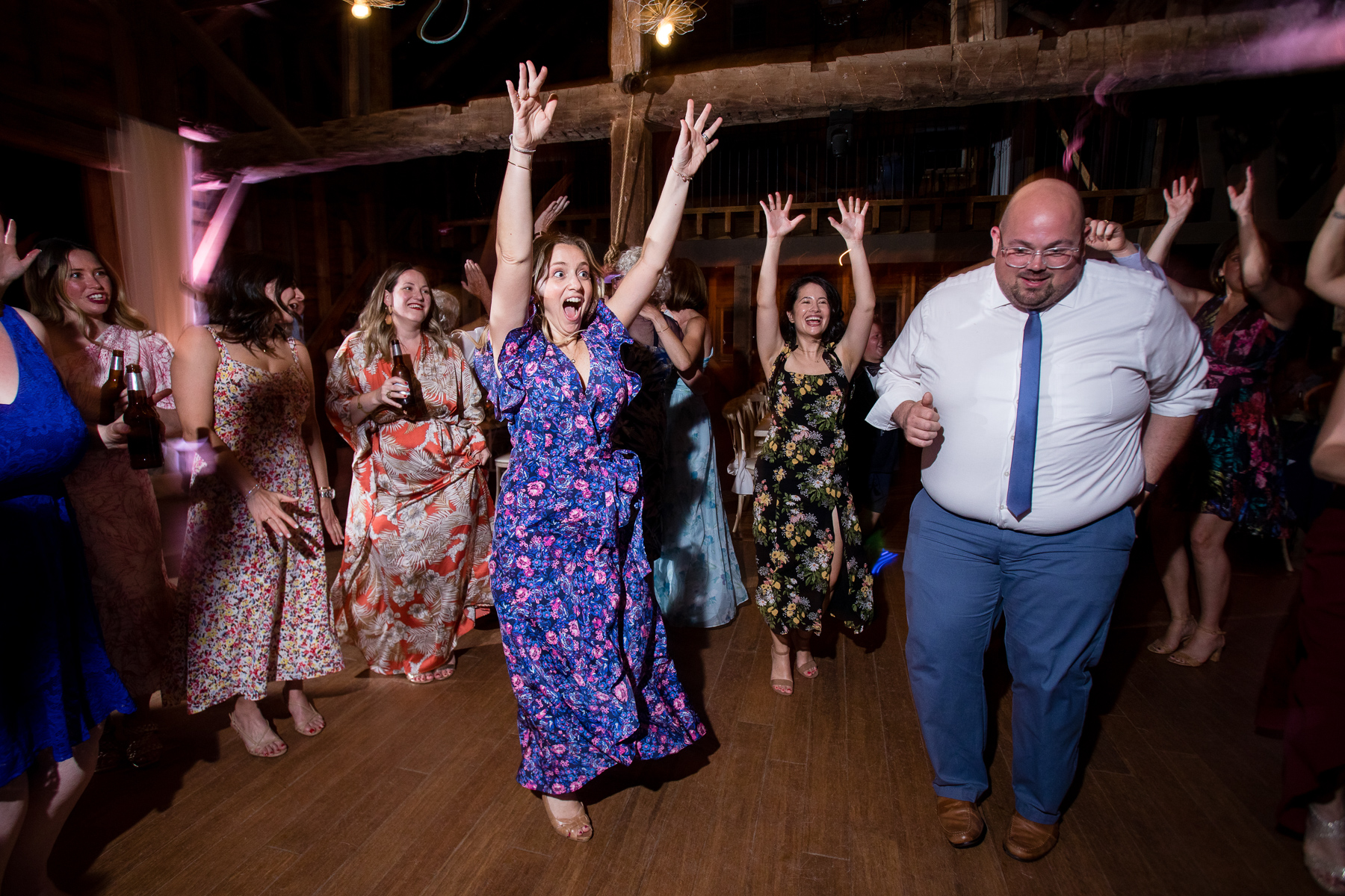 A group of guests laughing and having a great time at a wedding reception at Blenheim Hill Farm