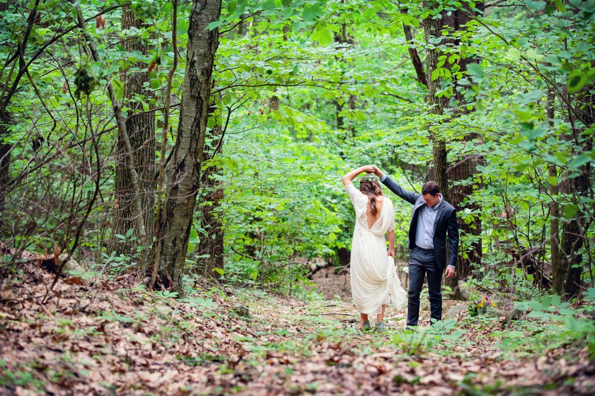 bride and groom dancing in the forest