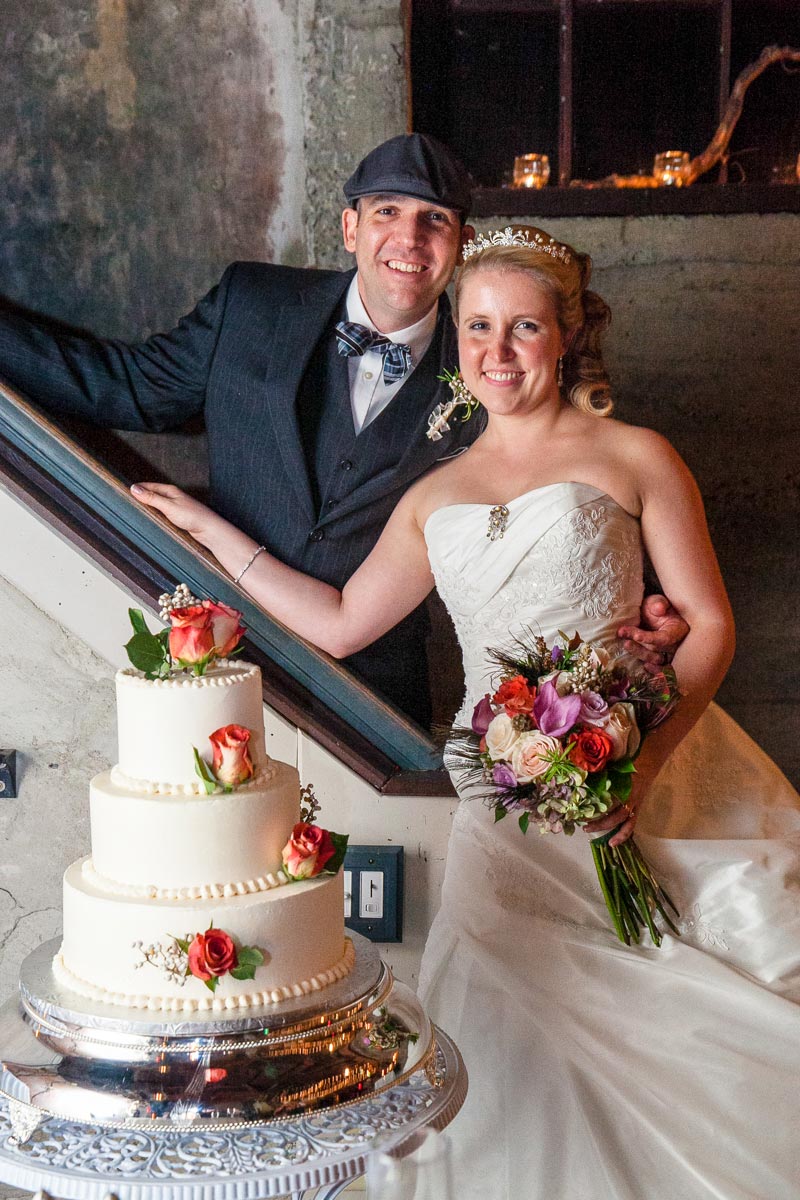 The couple cutting their wedding cake at their Santarella wedding