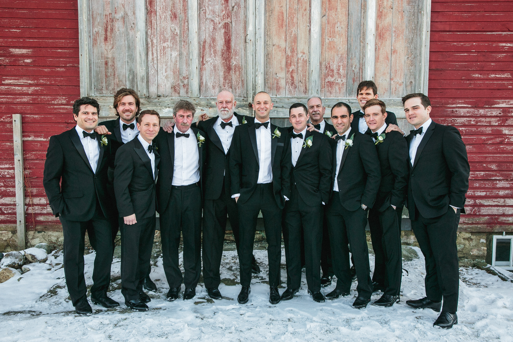 groom and his men in front of the barn in the snow at Gedney Farm