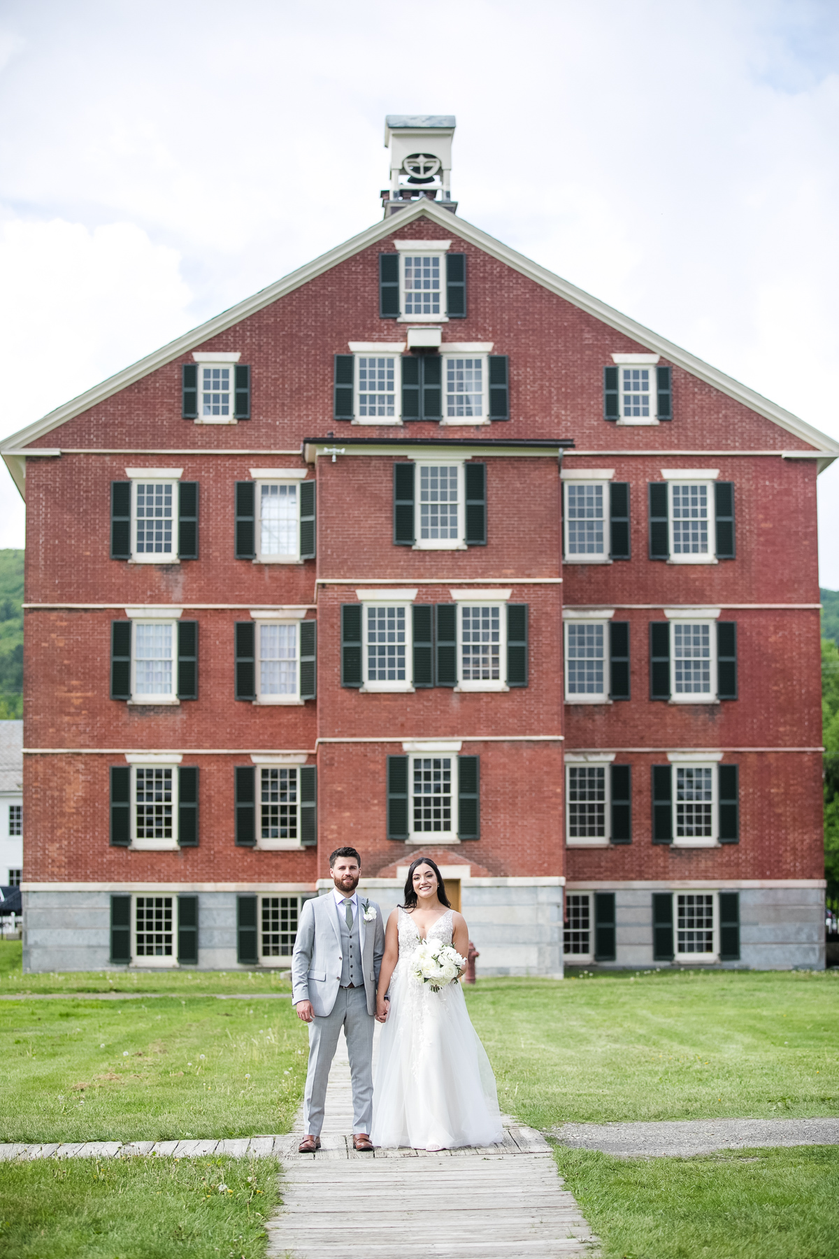 The couple having a moment alone at Hancock Shaker Village on their wedding day.