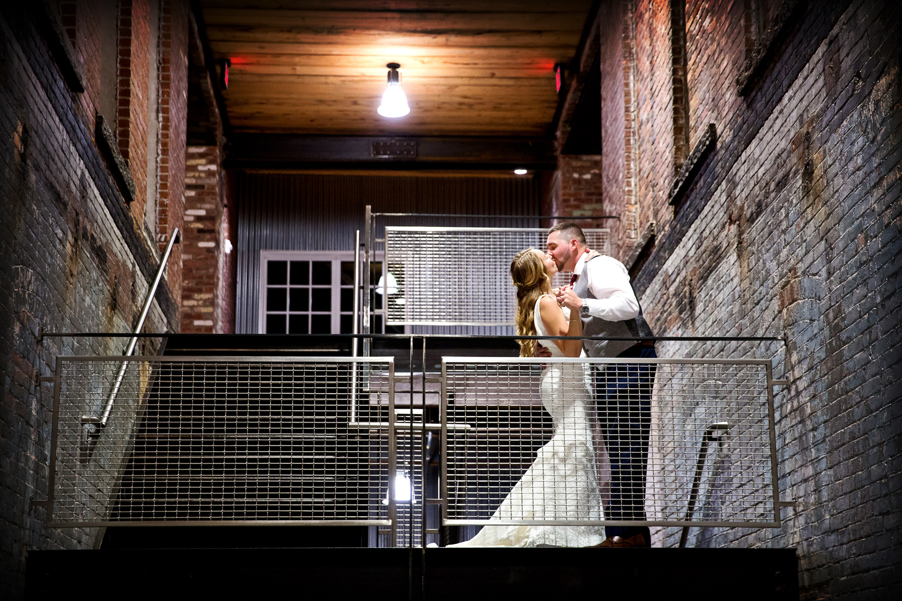 A bride and groom kiss during their wedding at Mass Moca