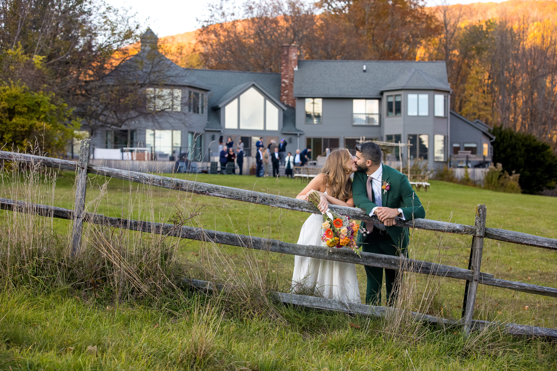 the bride and groom kissing in front of the Brookman Estate