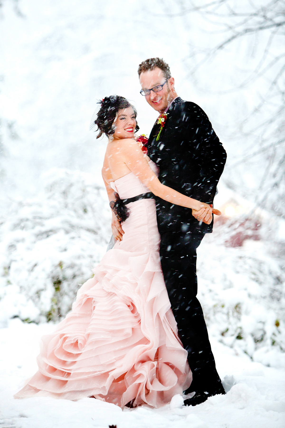 snowy photo of a bride and groom  at Race Brook Lodge
