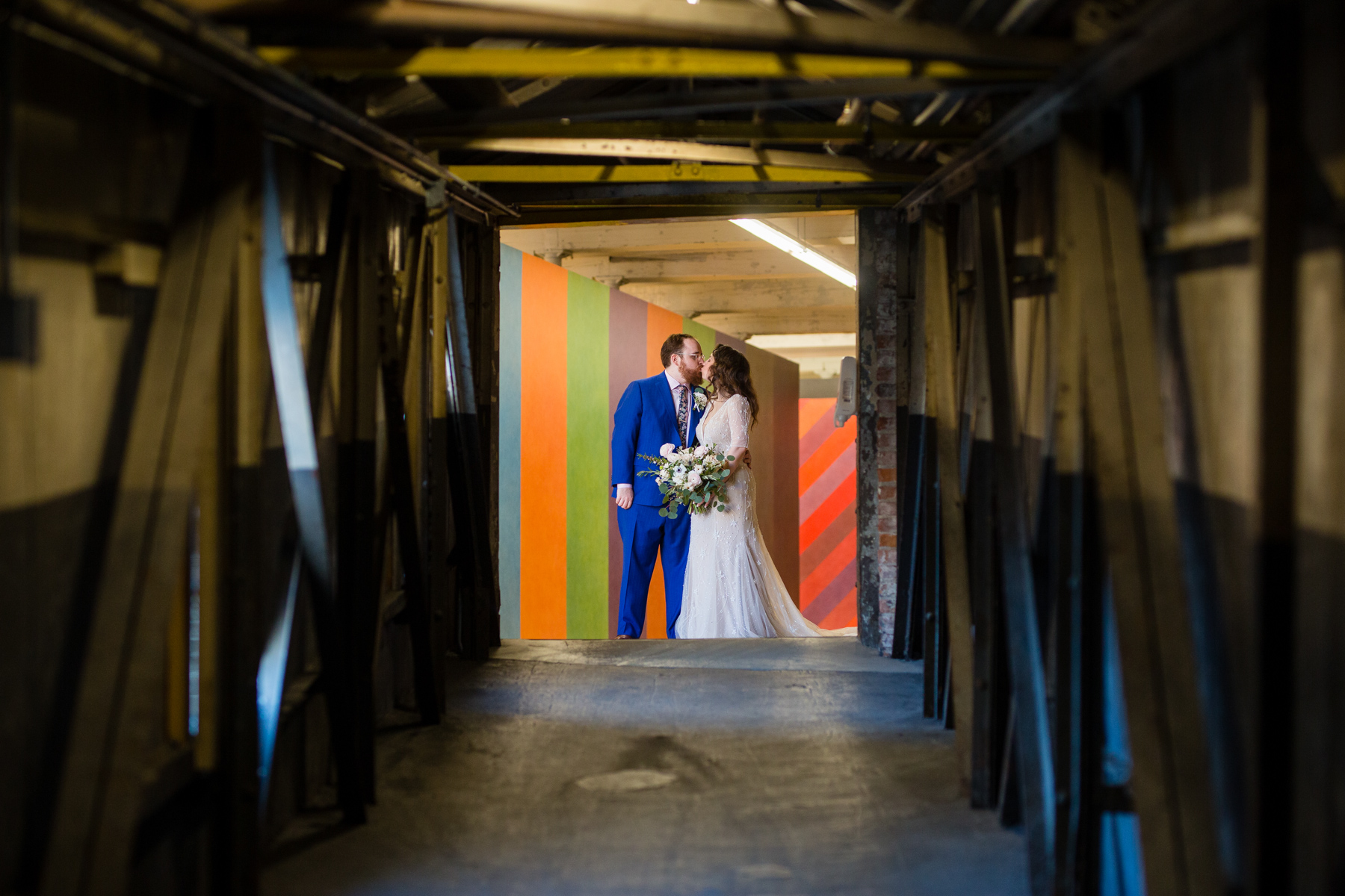 a bride and groom share a kiss at MASS MoCA