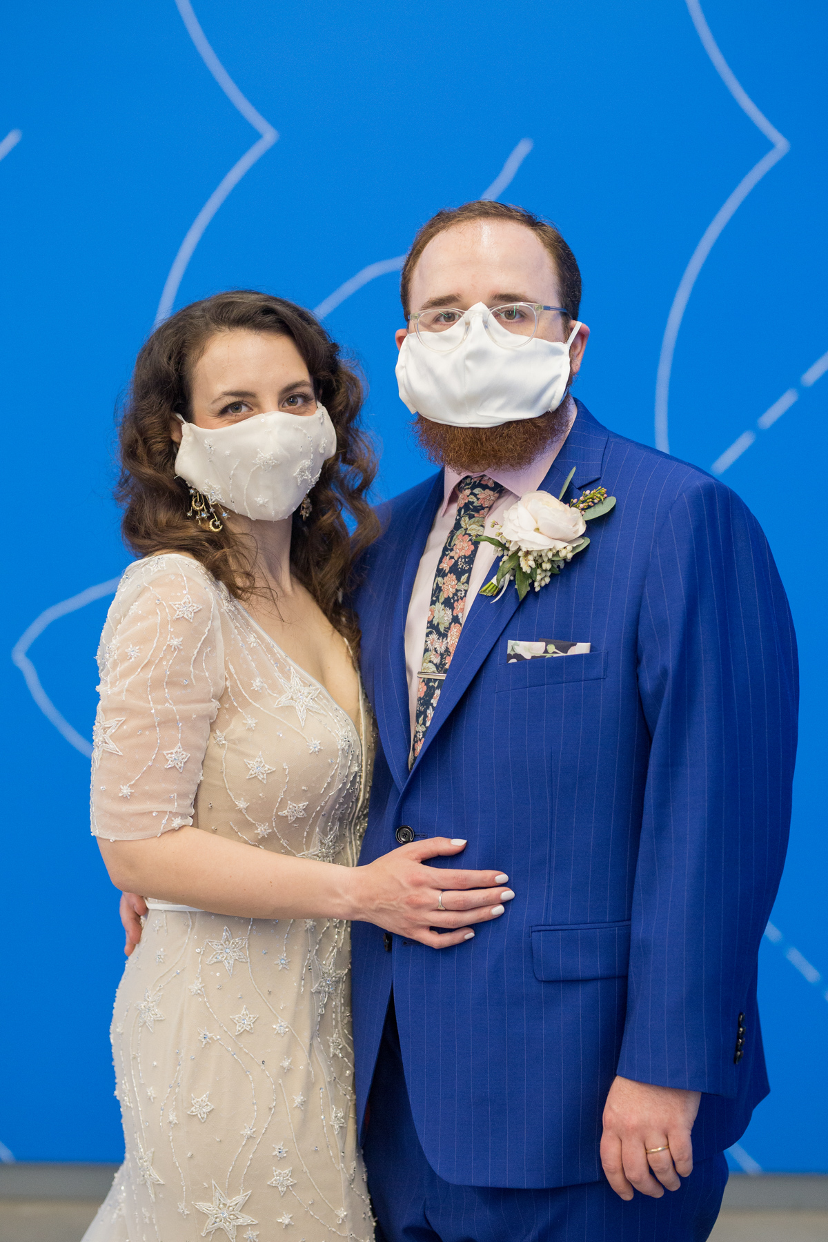 bride and groom wearing face masks