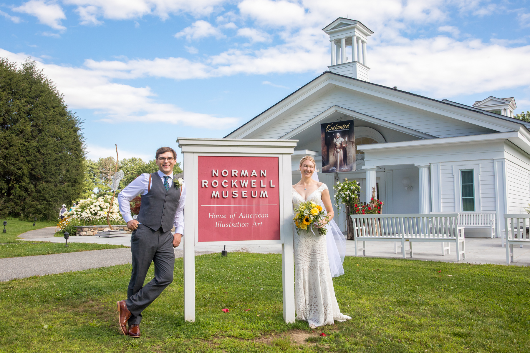 A bride and groom in front of the Norman Rockwell Museum