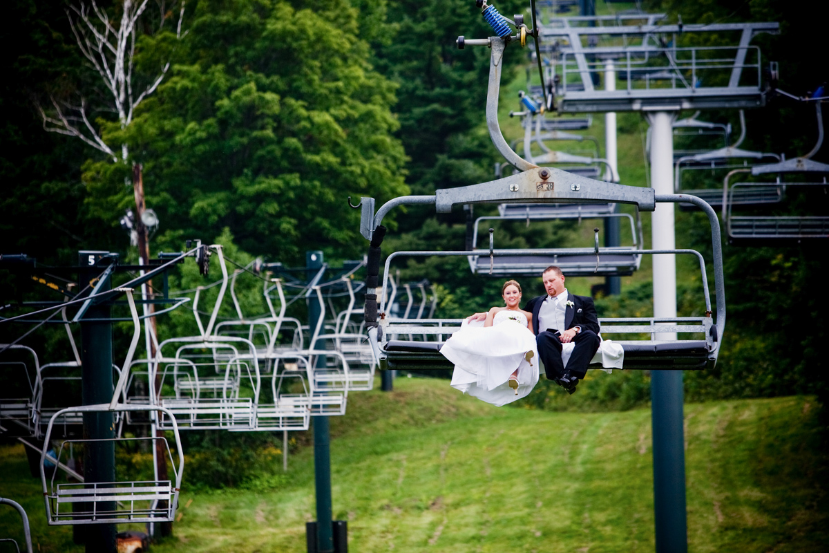 bride and groom on a chairlift at jiminy peak mountain resort