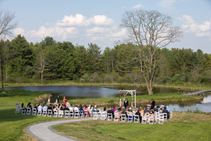 wedding ceremony with a pond at Blenheim Hill Farm