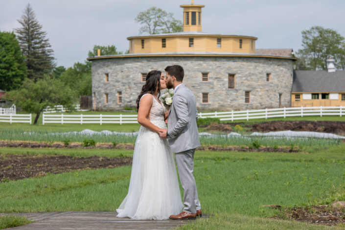 kissing in front of the round barn at Hancock Shaker Village